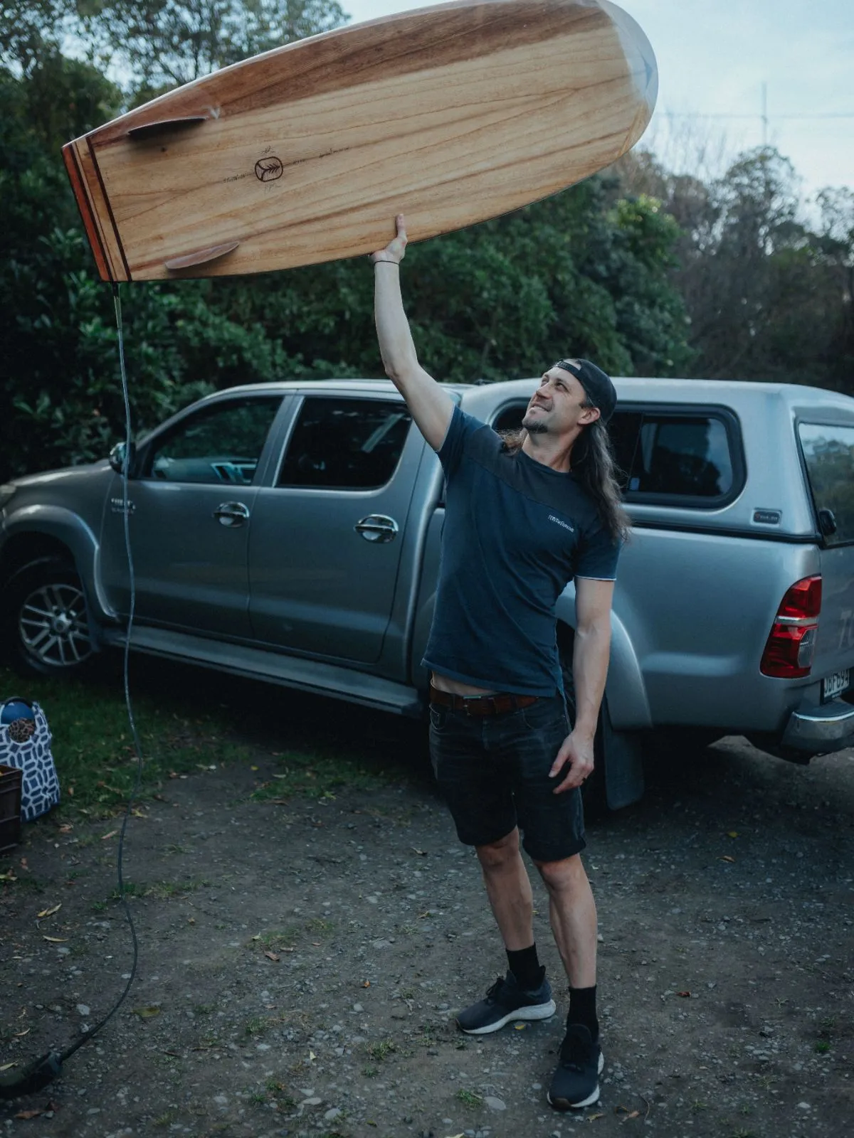 A builder lifting a finished board overhead